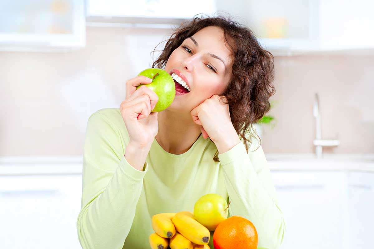 A beautiful woman eating fruits