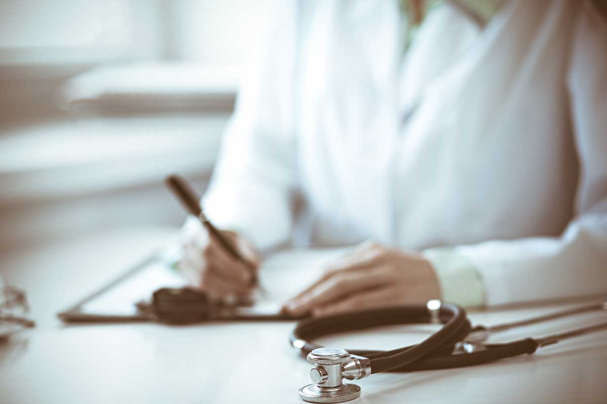 Doctor writing a medical note