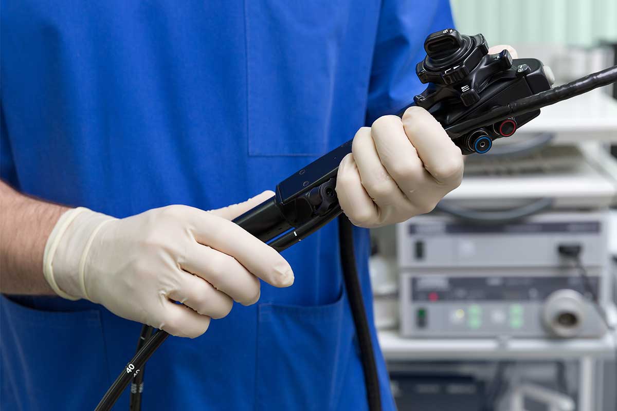 The doctor holding endoscope in the hands